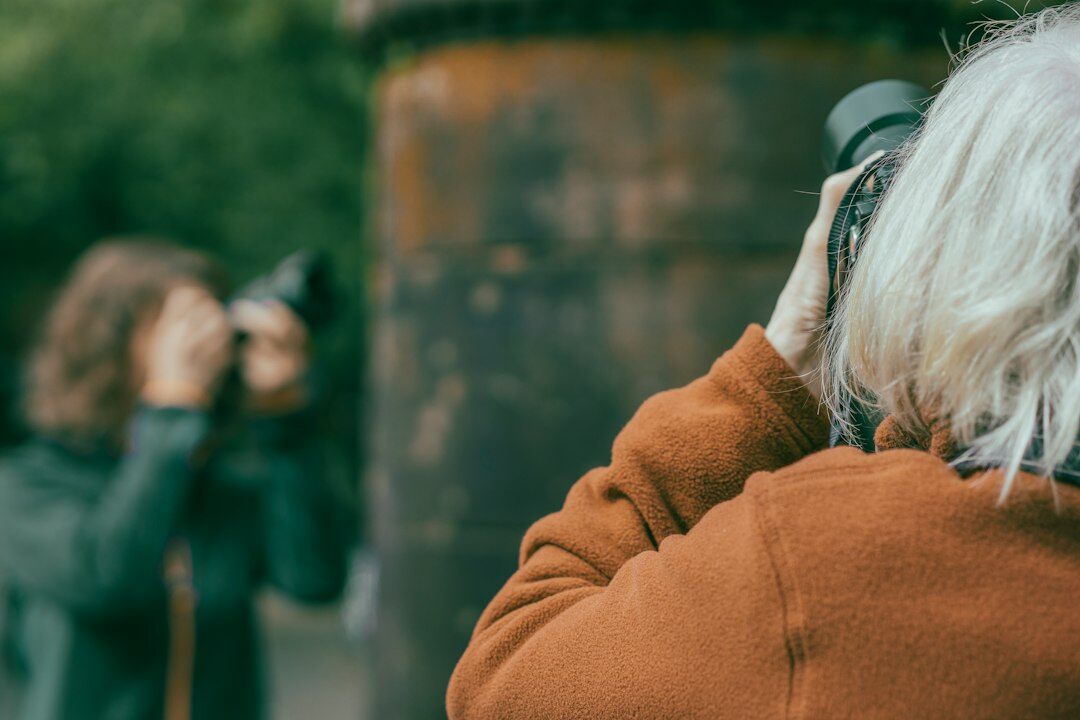Documentary photographer interviewing an elderly woman in her Danish home