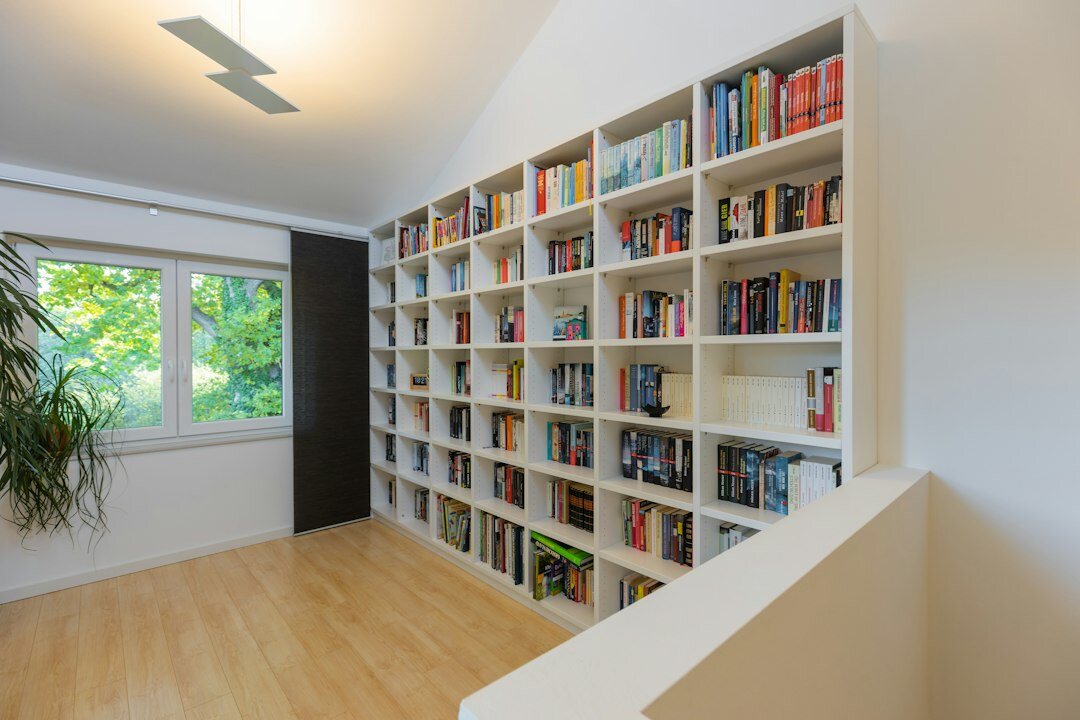 Bright editorial office with bookshelf and window light